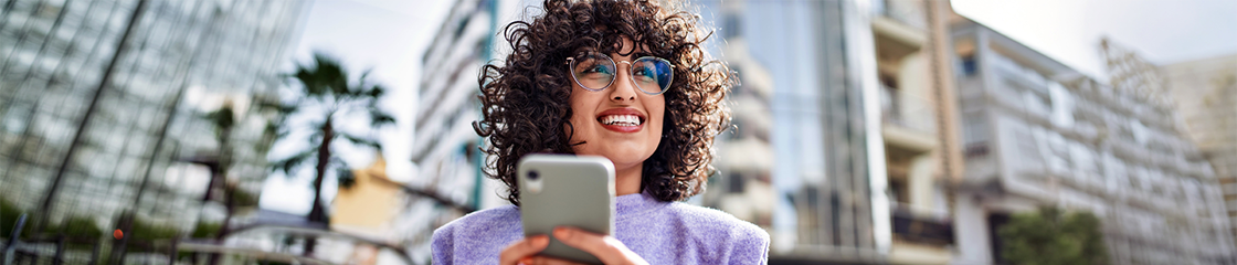 Woman with curly hair on smartphone